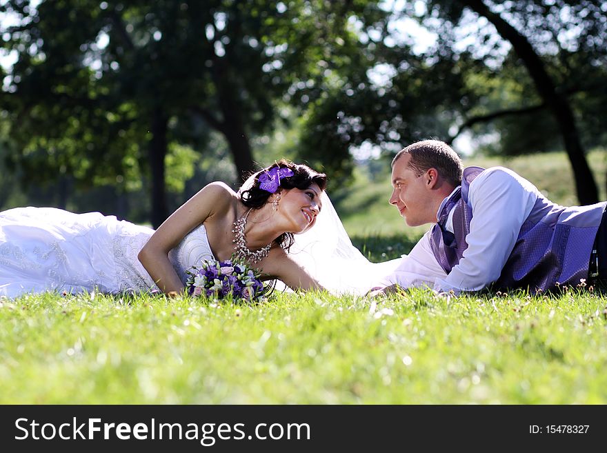 Bride and groom in summer park