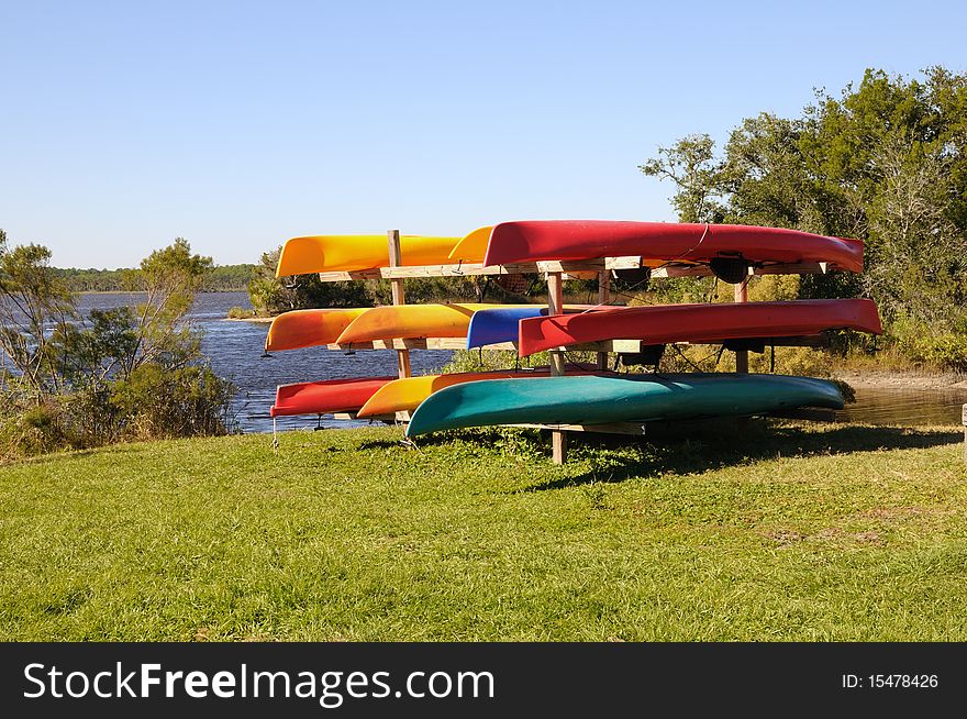 A colorful rack of kayaks in various colors at Tomoka State Park near Ormond Beach, Florida.