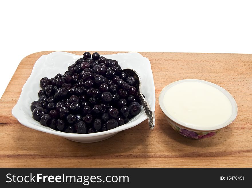 Blueberries and sour cream isolated on white