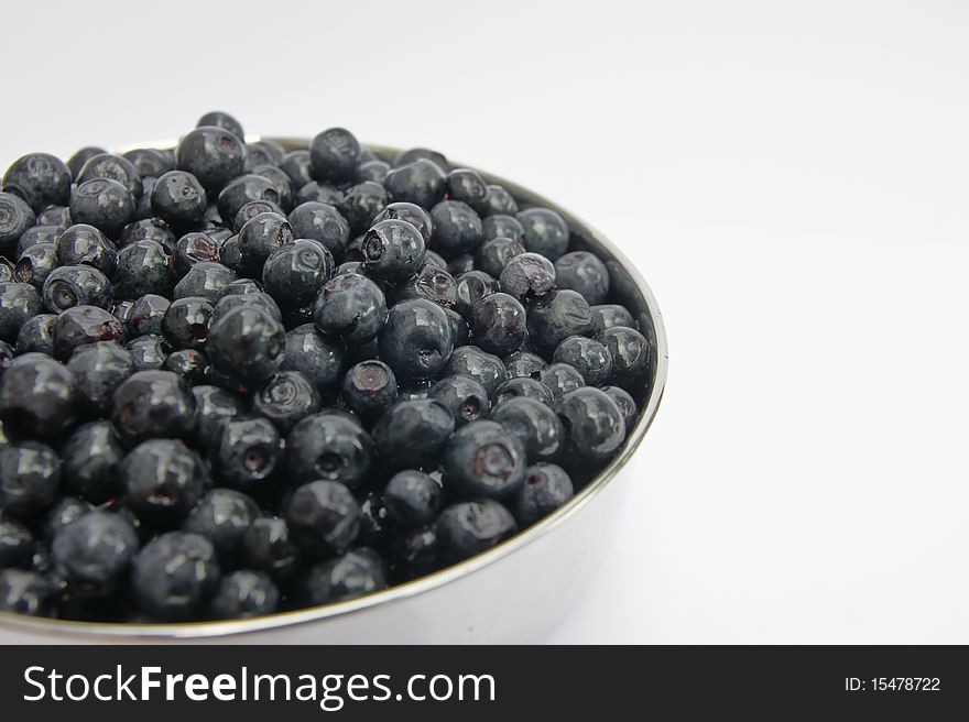 Bowl of blueberries on white background