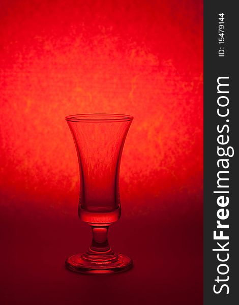 One glass on red color background