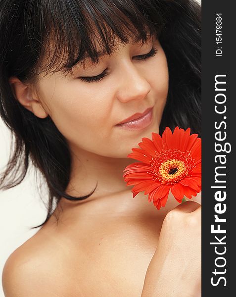 Young beautiful woman with red flower