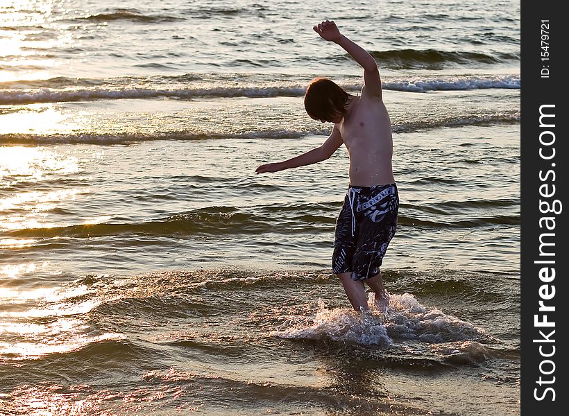 Teenage boy boarding in water. Teenage boy boarding in water
