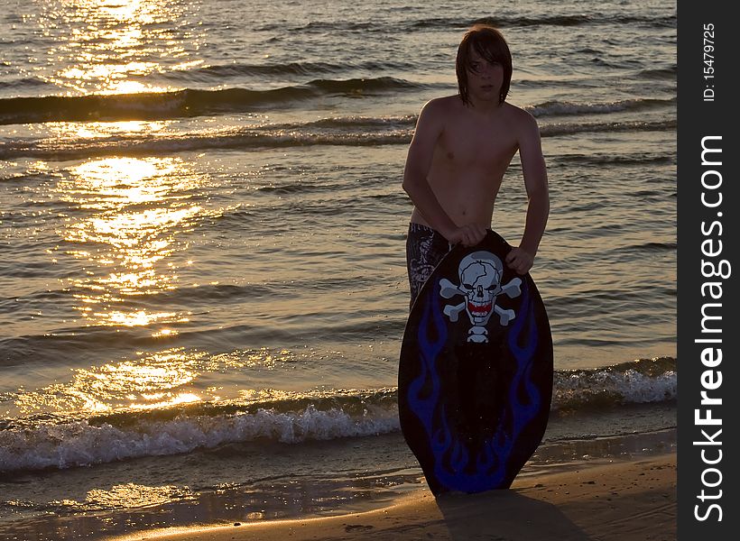 Teenage boy boarding in water. Teenage boy boarding in water