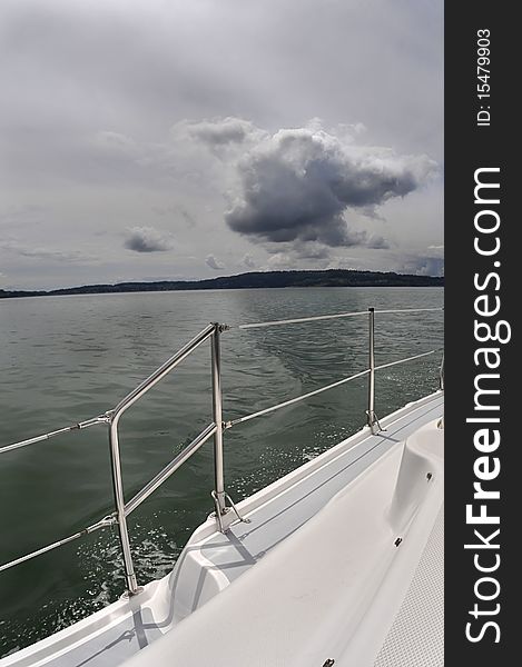 View of seascape  from the deck of a sailboat. Grey storm and green sea. View of seascape  from the deck of a sailboat. Grey storm and green sea.