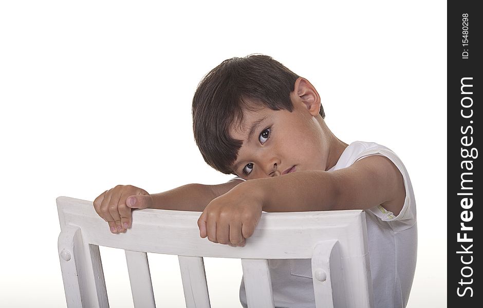A studio image of a bashful young boy.