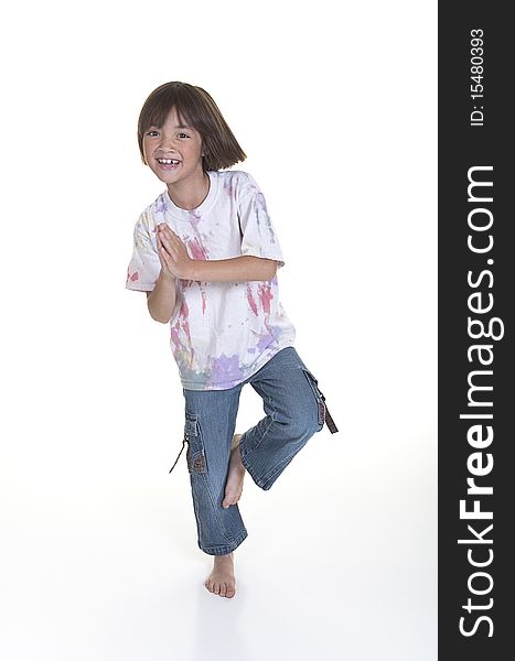 A young girl has fun attempting a yoga pose. A young girl has fun attempting a yoga pose.