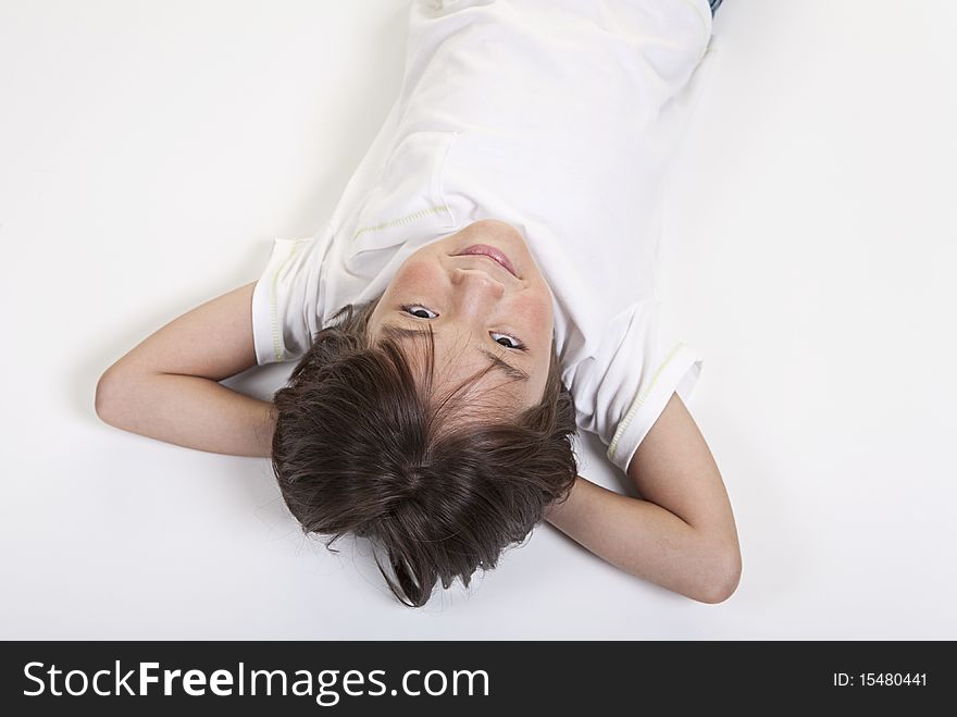 A young girl lays down on floor in an upside down photo. A young girl lays down on floor in an upside down photo.