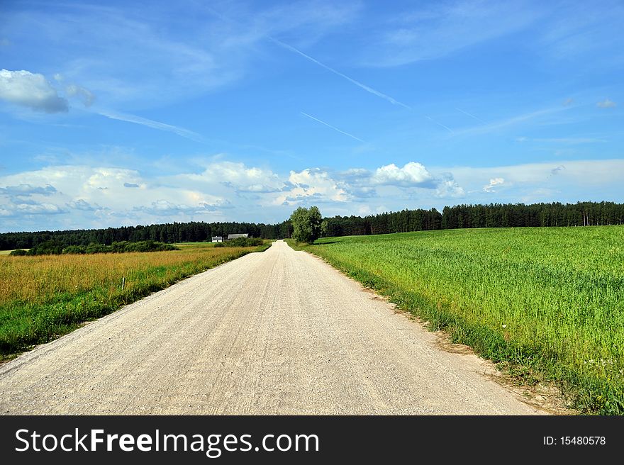 Rural road among fields and sky with clouds. Rural road among fields and sky with clouds