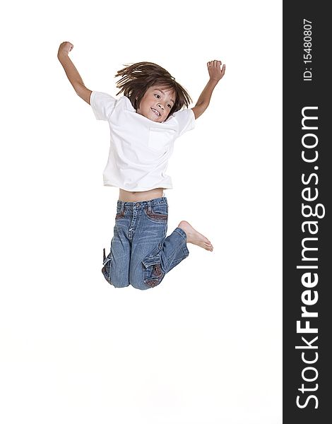 A young girl jumps up in the air in this studio image. A young girl jumps up in the air in this studio image.