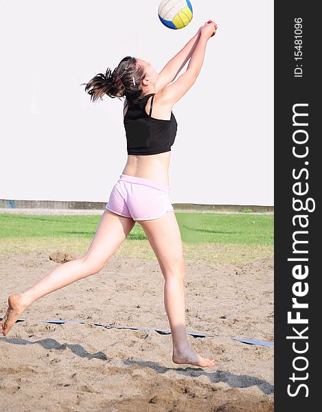 Girl playing beach volleyball on the beach