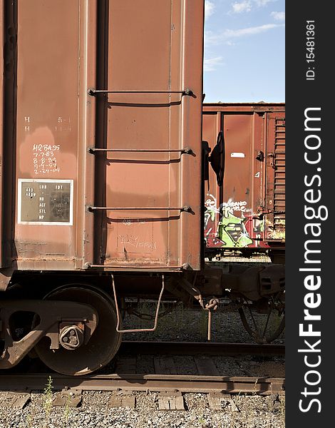 Train Boxcars with Graffiti Against a Blue Sky. Train Boxcars with Graffiti Against a Blue Sky