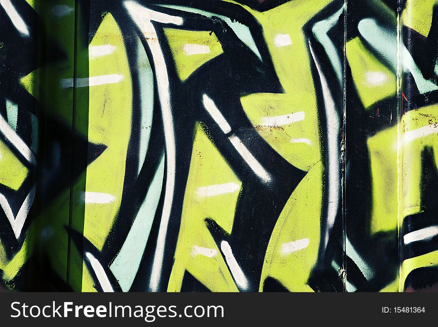 Colorful black and green and blue graffiti on the side of a train. Colorful black and green and blue graffiti on the side of a train