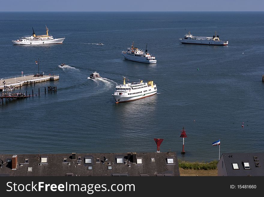 Ferry service close to Helgoland. Small boats carry passengers to bigger boats.