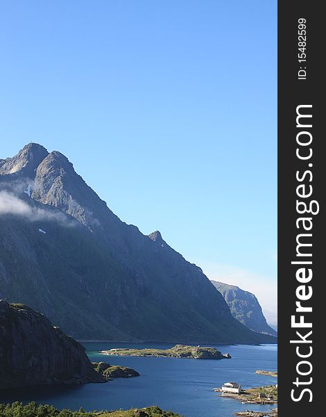 The Himmeltinden mountain mirroring in the fjord of Tangstad , Lofoten islands. The Himmeltinden mountain mirroring in the fjord of Tangstad , Lofoten islands