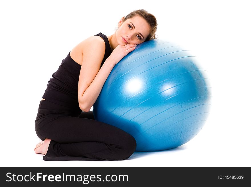 Young tired and very attractive woman with blue fitness ball, studio shoot isolated on white background. Young tired and very attractive woman with blue fitness ball, studio shoot isolated on white background