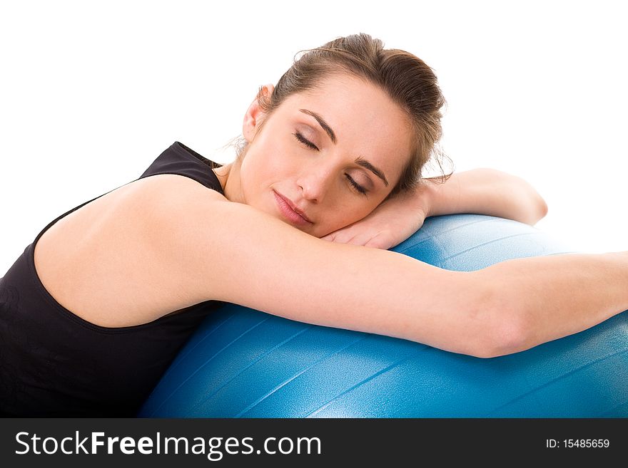 Young tired and very attractive woman with blue fitness ball, studio shoot isolated on white background. Young tired and very attractive woman with blue fitness ball, studio shoot isolated on white background