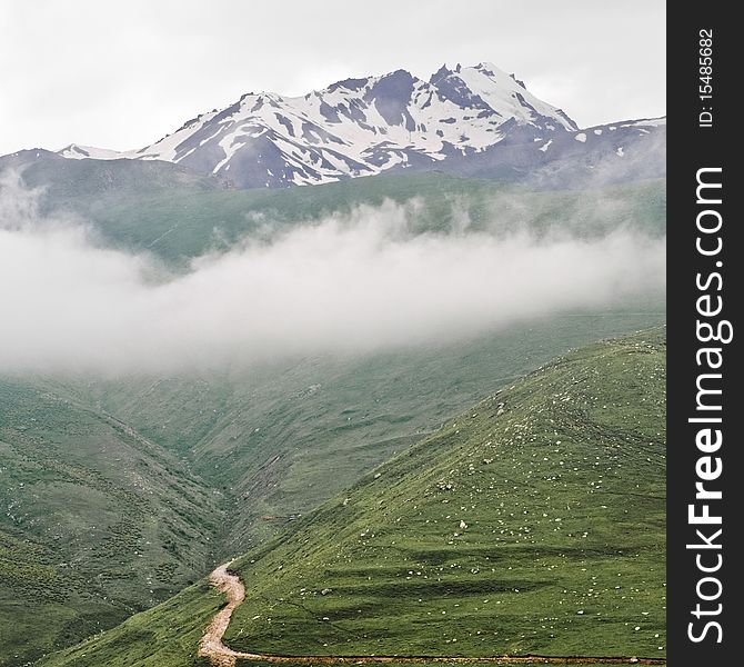 Way to Kazbegi mountain in Georgia, with dark clouds and green grass. Way to Kazbegi mountain in Georgia, with dark clouds and green grass