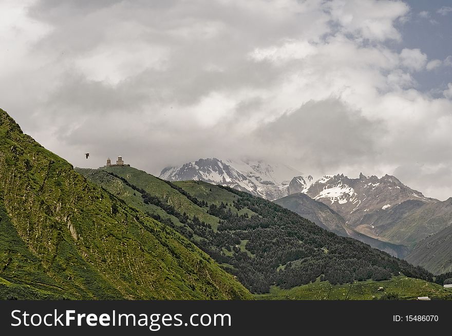 Kazbegi mountains in Georgia, Kachetia with eagle passing through shot. Kazbegi mountains in Georgia, Kachetia with eagle passing through shot