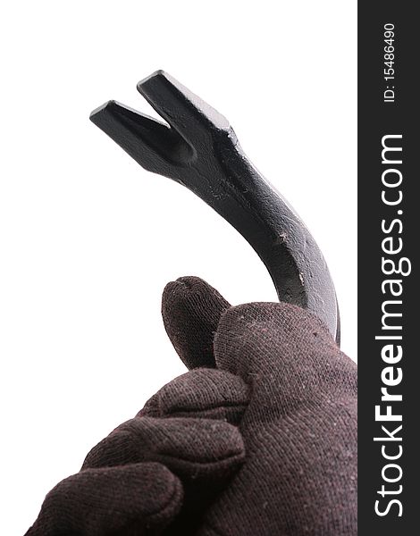 The hand in a black glove made of cloth holds crowbar.