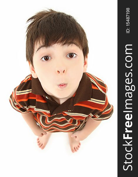 Adorable seven year old french american boy looking up towards camera over white background. Adorable seven year old french american boy looking up towards camera over white background.