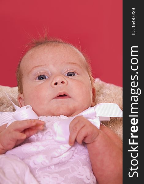 Newborn baby with a bright pink backkground. Newborn baby with a bright pink backkground