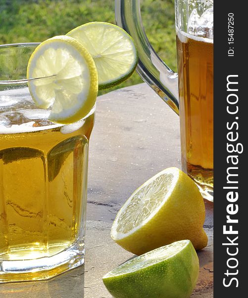 Refreshing summer drink with lemon and lime slices