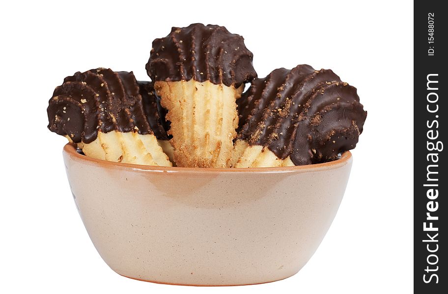 A plate of biscuits with chocolate icing on a white background