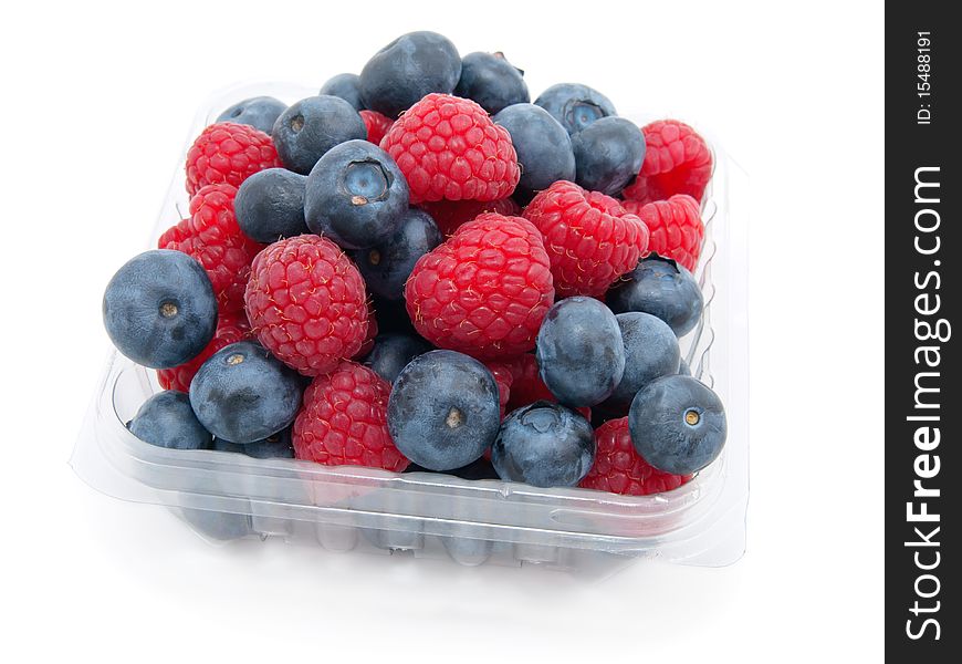 Transparent basket with a raspberry and a blueberry on a white background