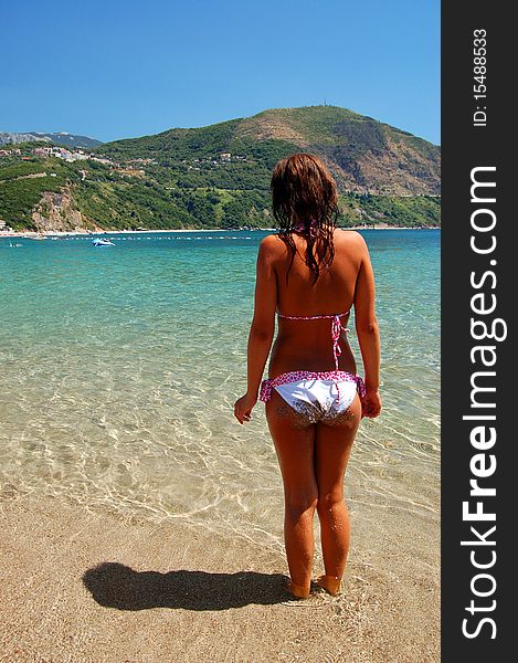 A girl on adriatic sandy beach in Montenegro. A girl on adriatic sandy beach in Montenegro