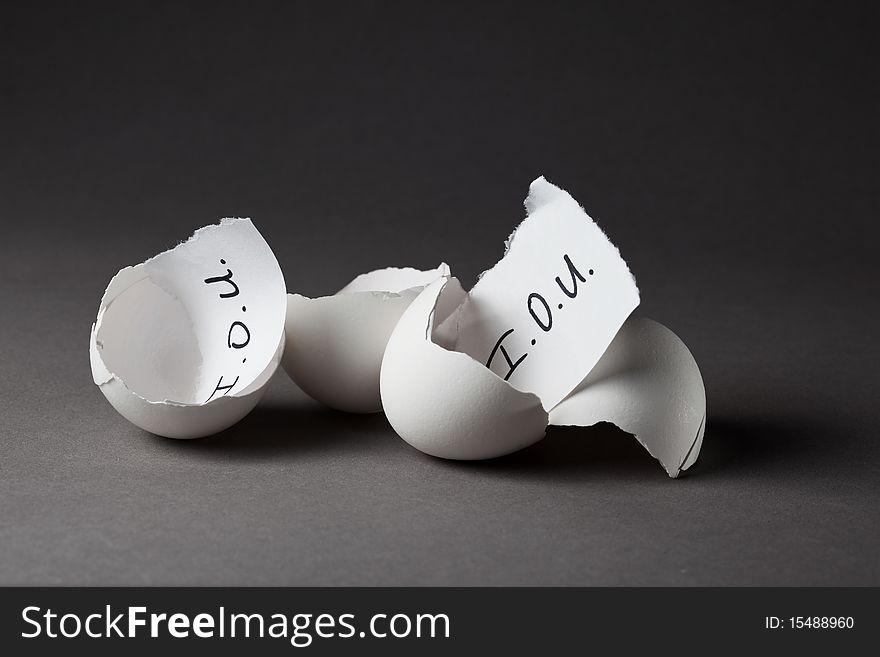 Borrowing money from the nest egg (savings). IOU slips in cracked eggshells. Borrowing money from the nest egg (savings). IOU slips in cracked eggshells.