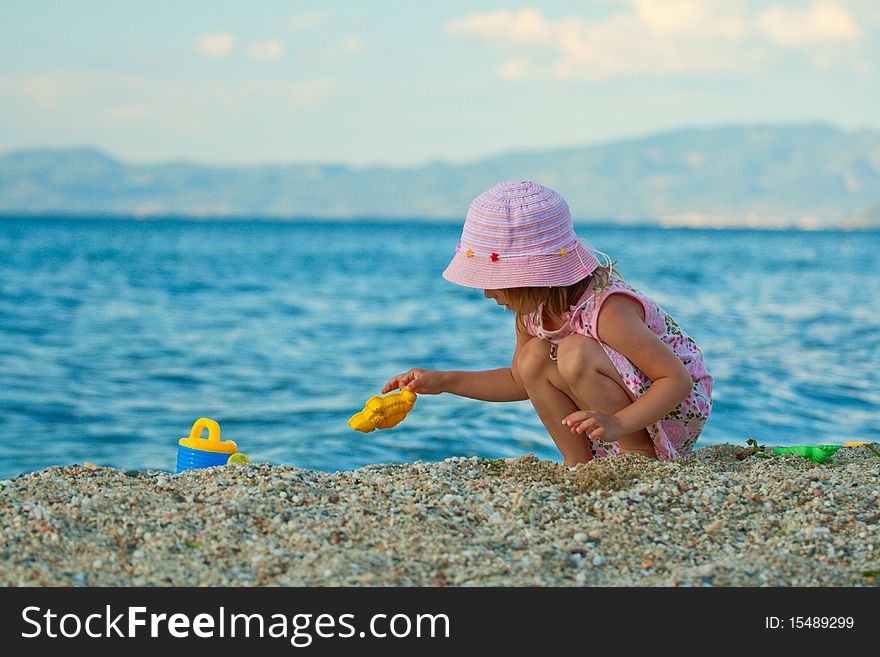 Little Pretty Girl Playing On The Beach.