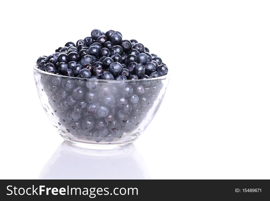 Blueberries in transparent glass dish with soft shadow on white background. Blueberries in transparent glass dish with soft shadow on white background