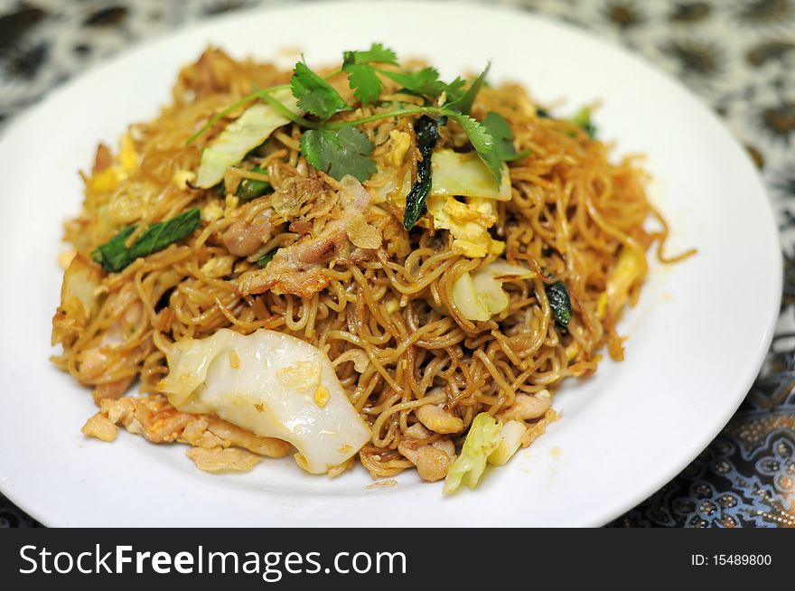 Indonesian-style fried noodle containing vegetables, chicken, eggs, and seasoned with sweet soy sauce. Indonesian-style fried noodle containing vegetables, chicken, eggs, and seasoned with sweet soy sauce