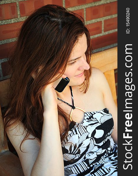 Female beauty talking on her cellphone outdoors.