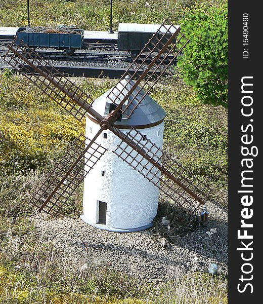 Model Windmill with a toy train in the background