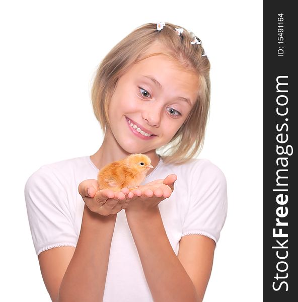 A happy little girl holding a baby chicken.