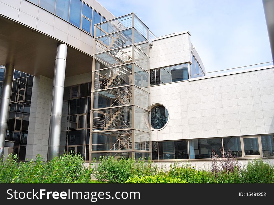 Building from glass and metal with a ladder