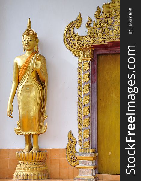 Golden image of Buddha and ancient door
