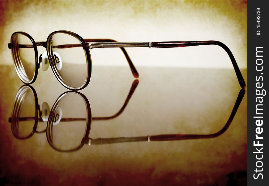 Closeup of Antique Eyeglasses on desk with reflection. Closeup of Antique Eyeglasses on desk with reflection