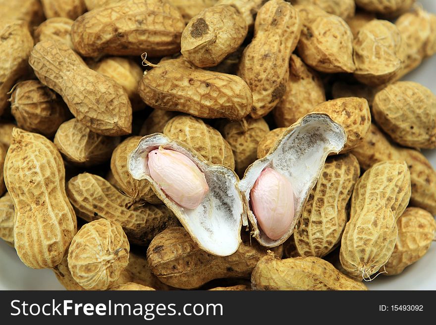 Peanuts and shells on bright background Photo taken on: 2010