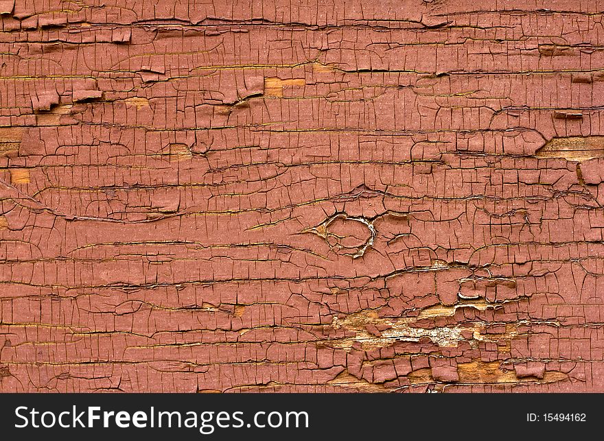 Old red oil paint peeling away from wood surface. Old red oil paint peeling away from wood surface.