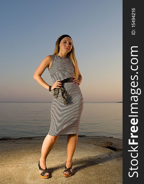 Attractive young woman standing at the seaside. Attractive young woman standing at the seaside