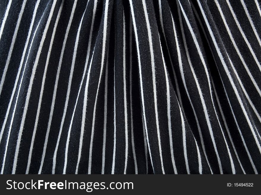 Striped black and white satin fabric background. Striped black and white satin fabric background