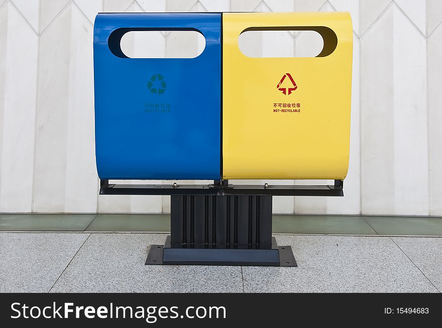 A waste and recycling bin placed side by side in a unique design. A waste and recycling bin placed side by side in a unique design.