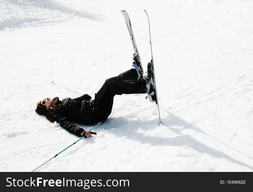 Skiing girl laying on the snow. Skiing girl laying on the snow