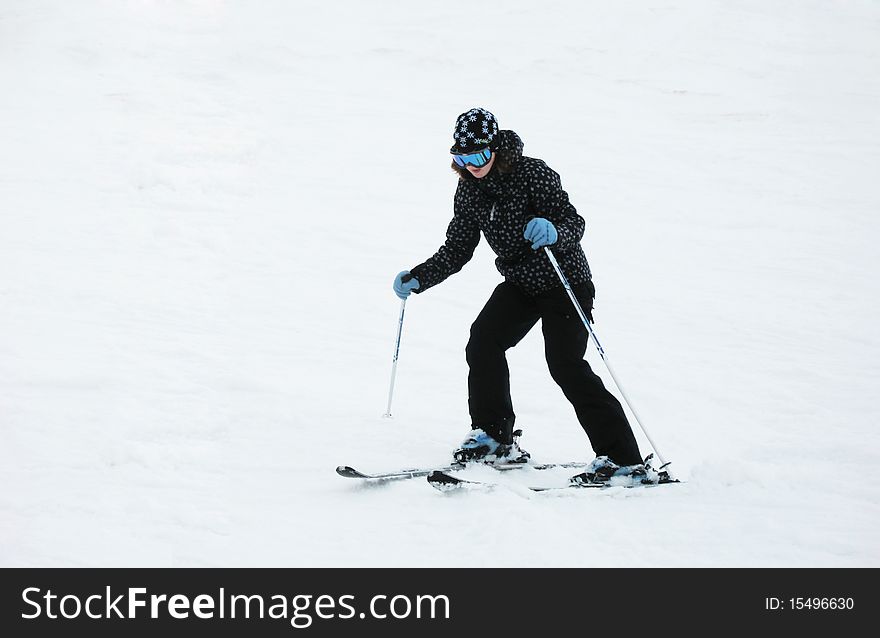 Woman in black jacket skies in Alps