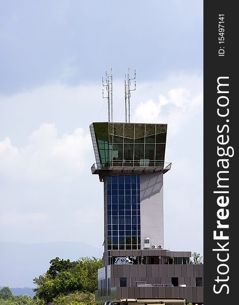Airport control tower with sky in the background.