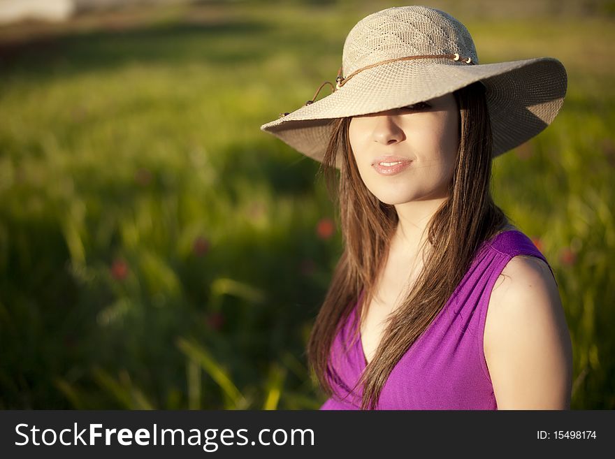 Young woman portrait wearing a big hat. Young woman portrait wearing a big hat.