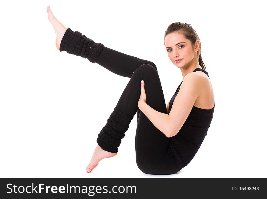 Young and attractive female makes some exercises on white floor, studio shoot isolated on white. Young and attractive female makes some exercises on white floor, studio shoot isolated on white